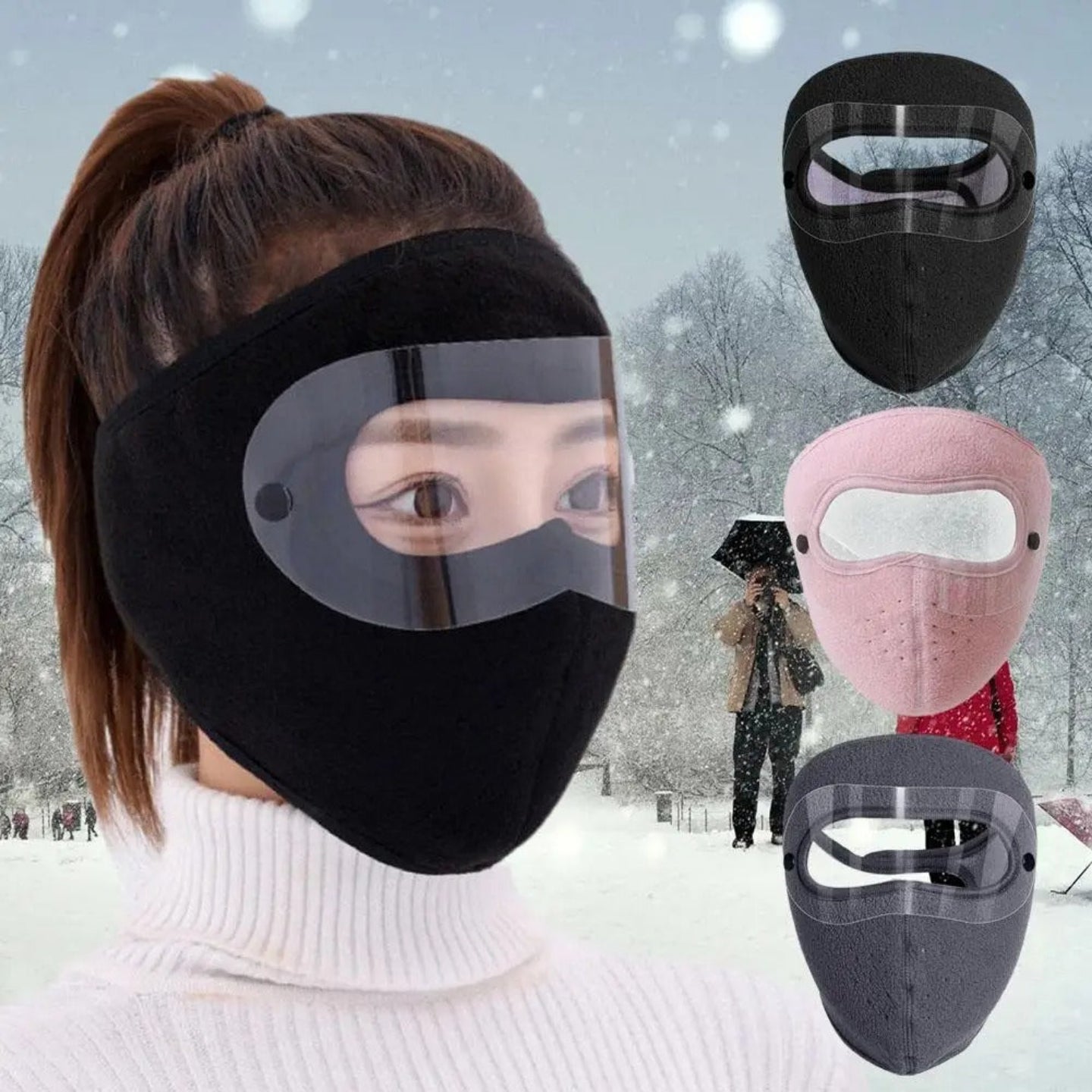 Person wearing a black face mask with a clear visor in a snowy landscape, with additional face masks displayed.